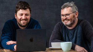 George and Andy sat at a laptop